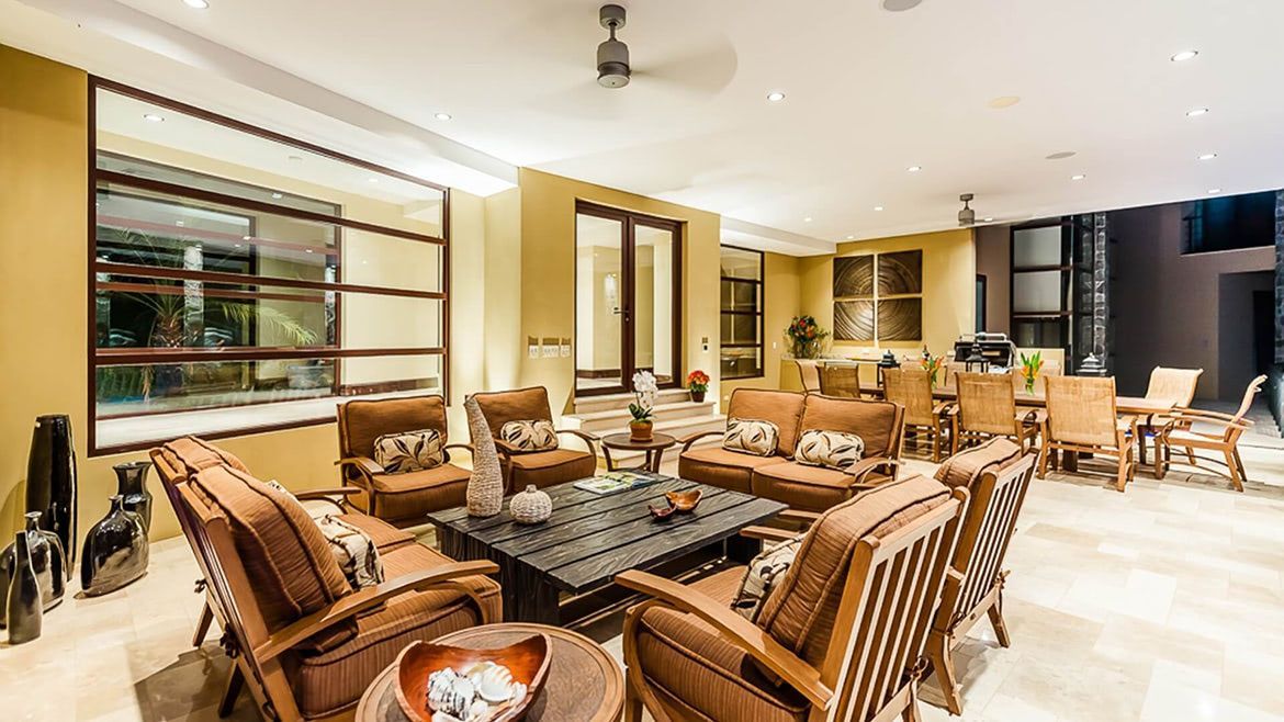 a living room filled with furniture and a ceiling fan .