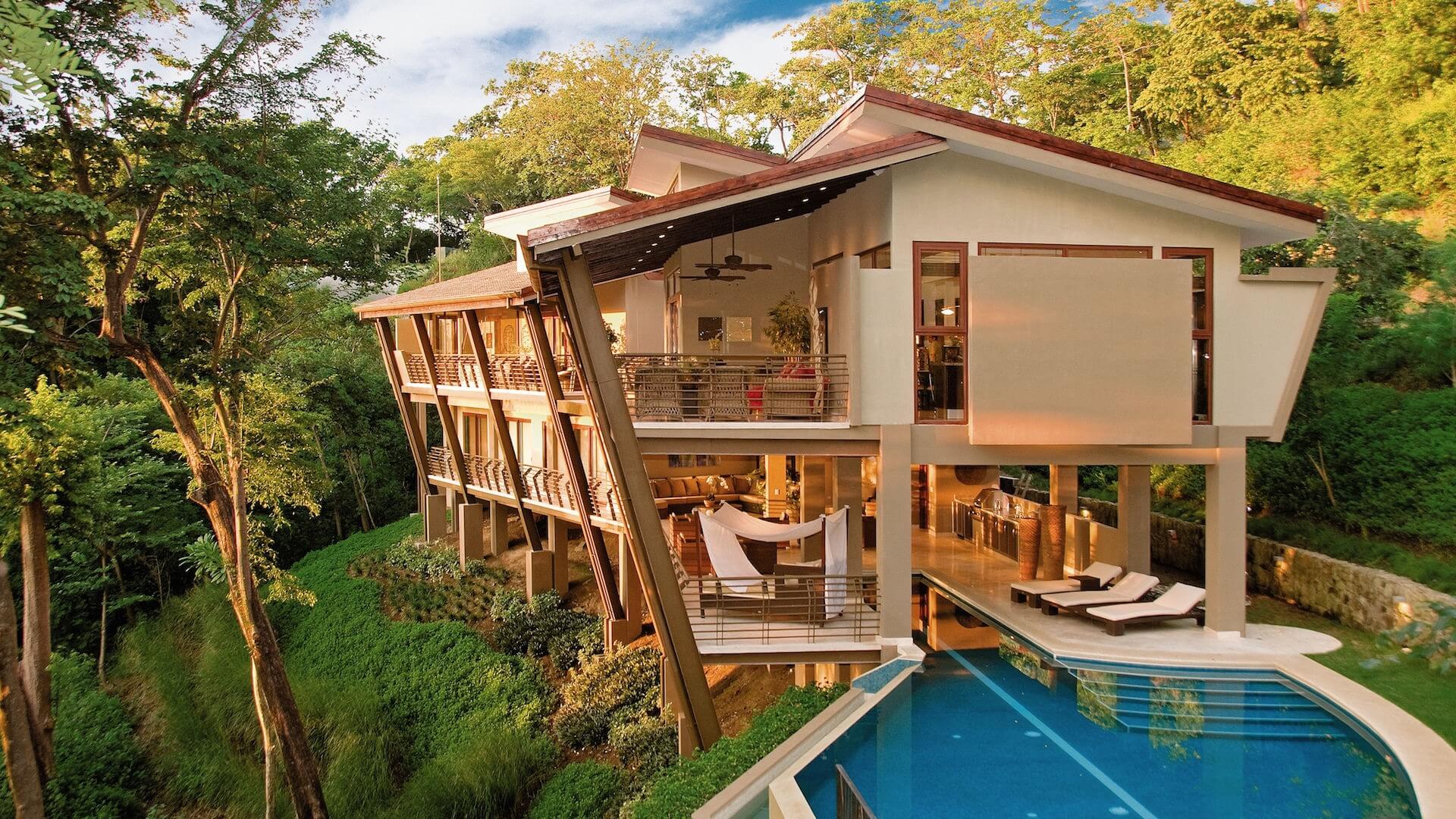 a large house with a swimming pool is surrounded by trees .