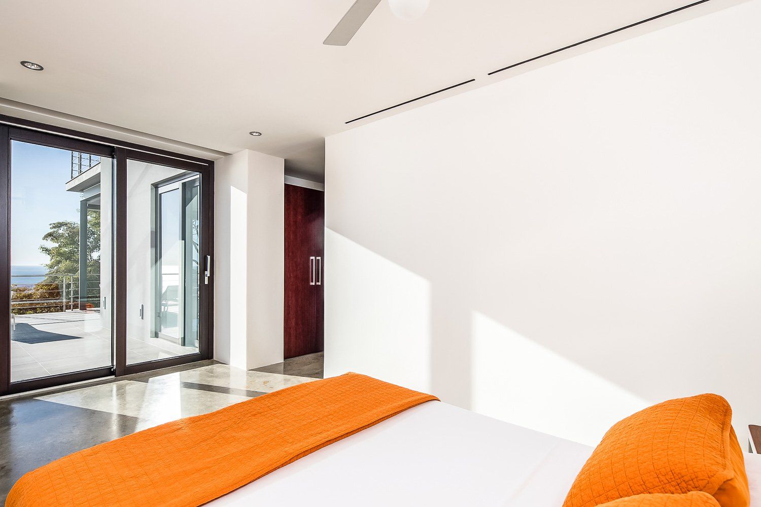 a bedroom with a large bed and sliding glass doors