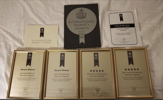 several awards are displayed on a bed with the word sarc on the bottom