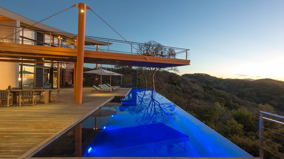 a large house with a swimming pool in front of it