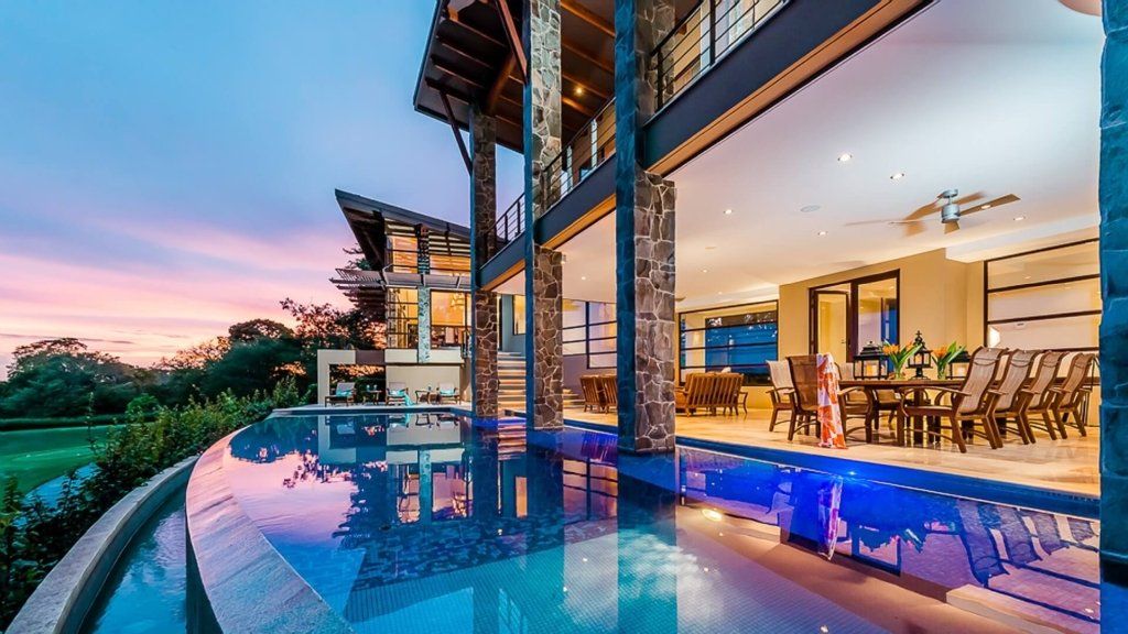 a large house with a swimming pool in front of it .