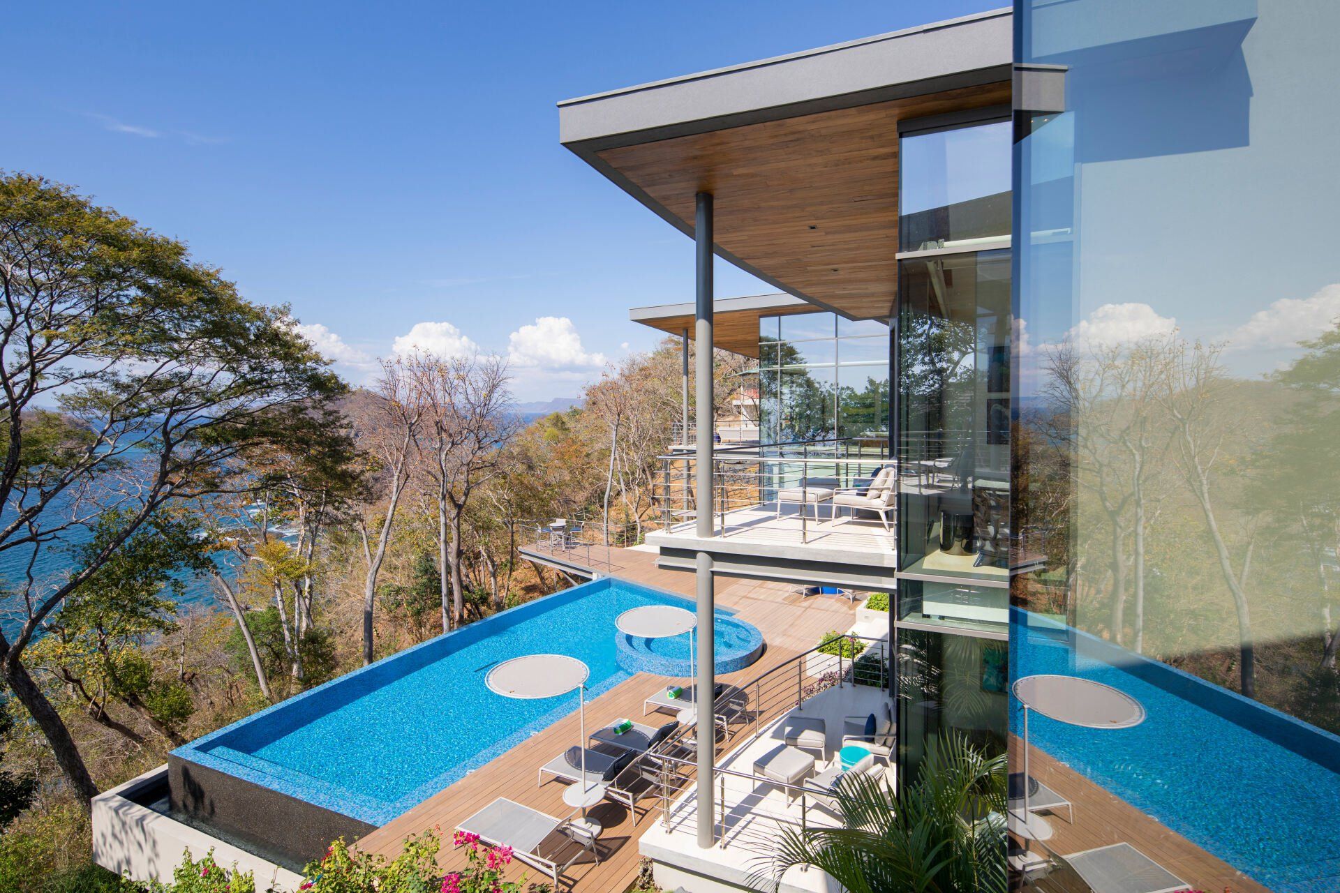 a large house with a swimming pool and a view of the ocean .