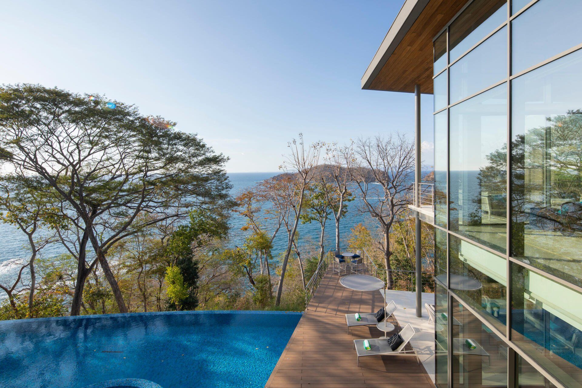 a large house with a swimming pool and a view of the ocean .