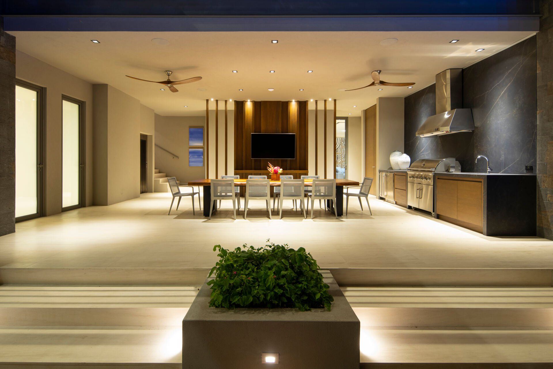 a large room with a dining table and chairs and a kitchen .