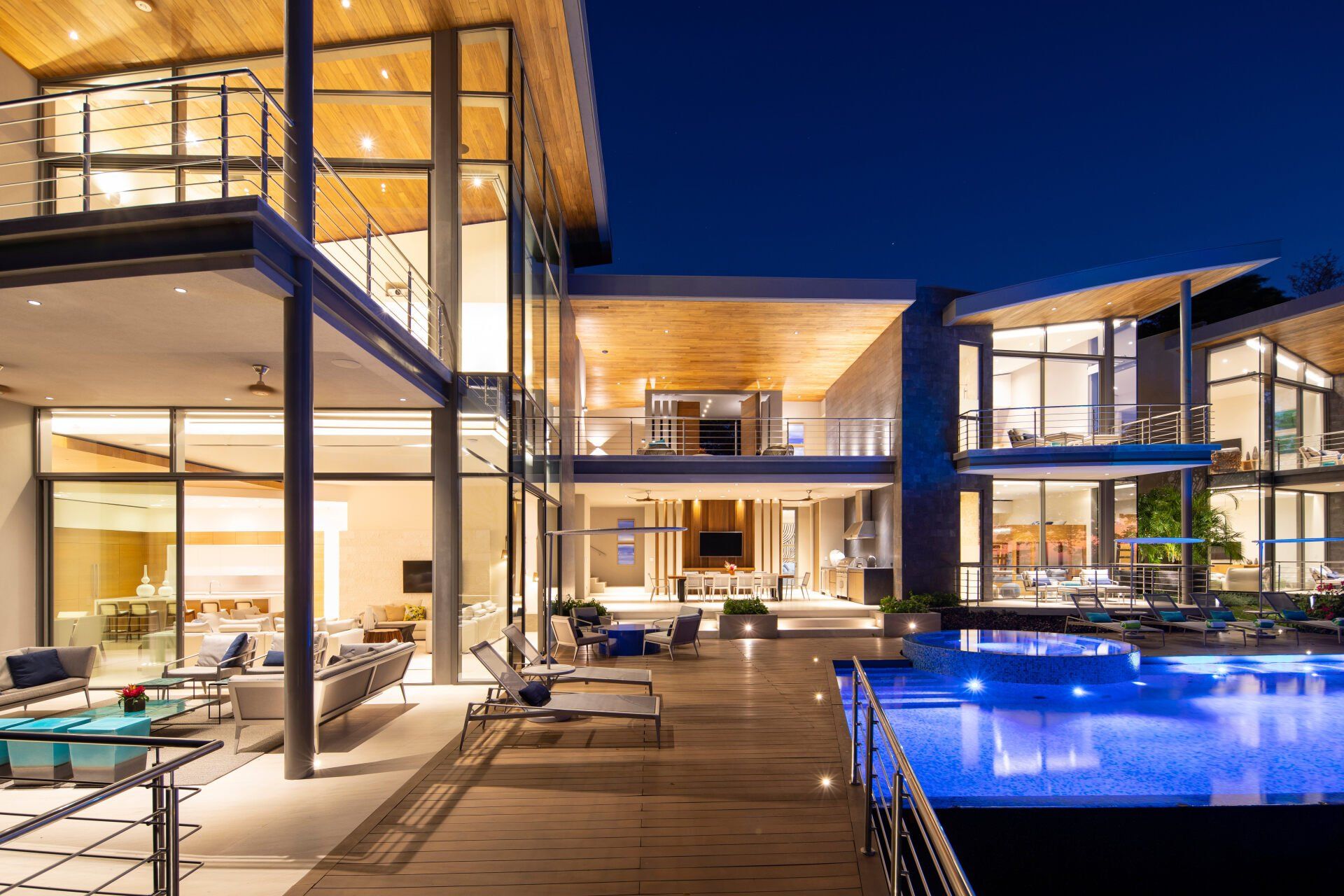 a large house with a swimming pool in front of it at night . - villa serena by sarco