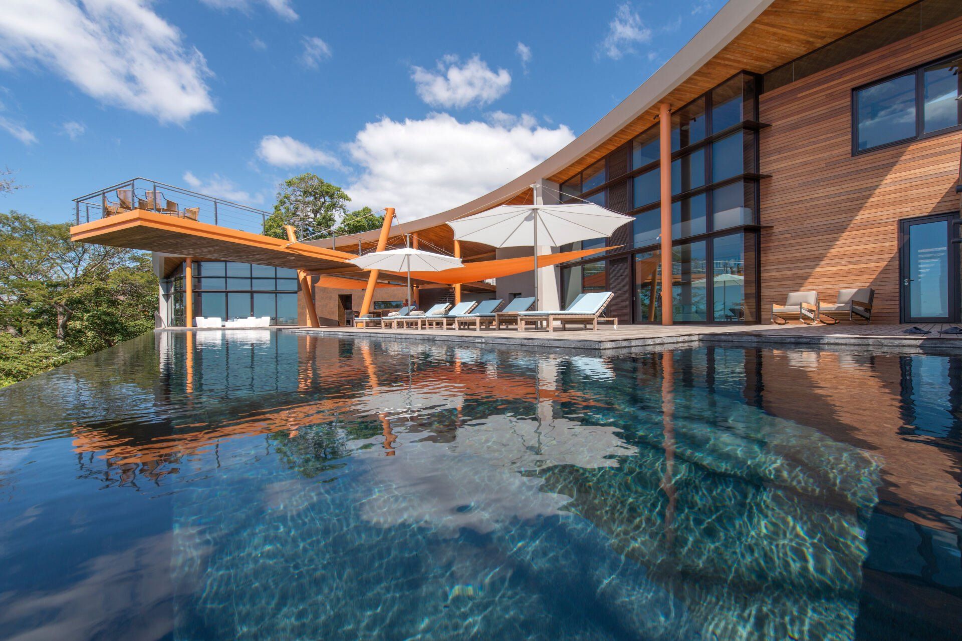 a large house with a swimming pool in front of it .