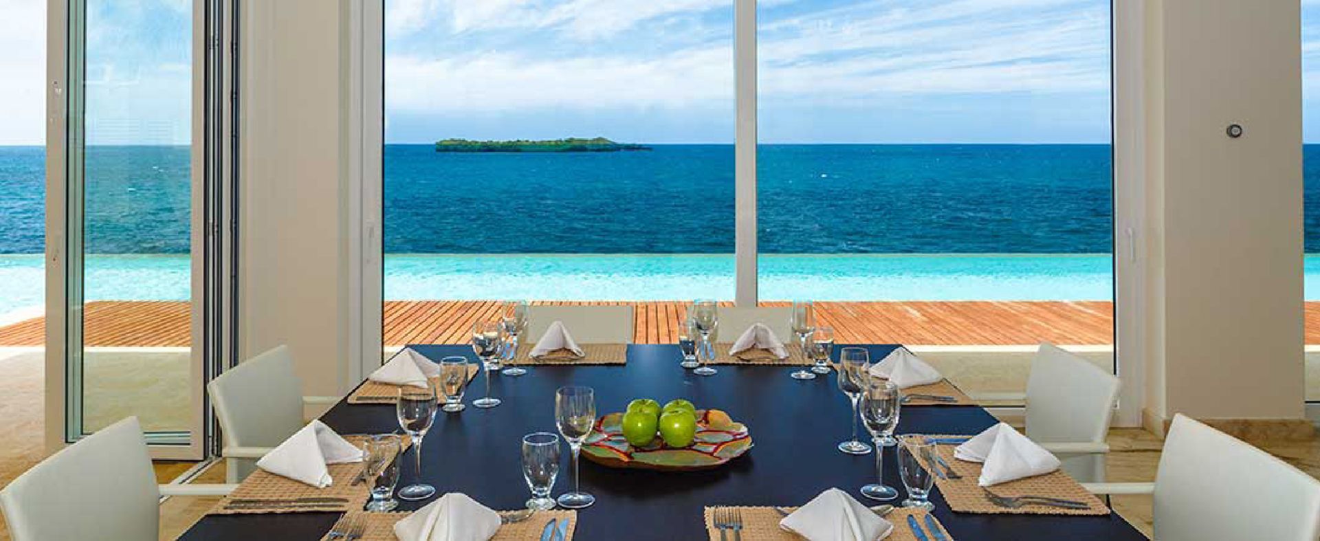 a dining room table with a view of the ocean .