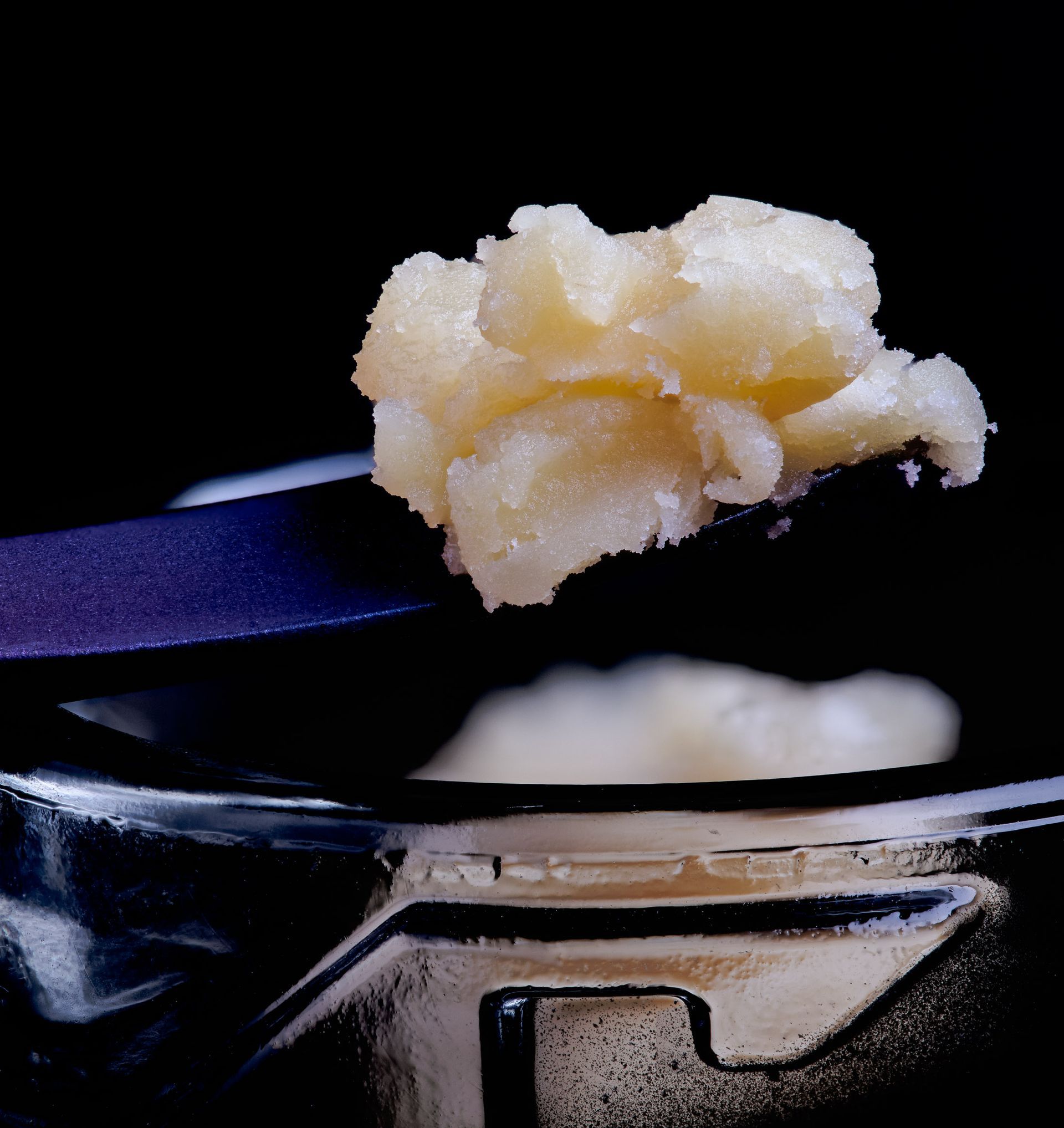 A close up of a spoon with a piece of food on it