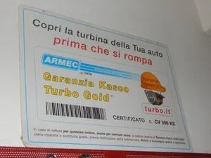 Italian ad for ARMEC turbo gold on a white sign, with blue and yellow text and a hard-hat graphic.