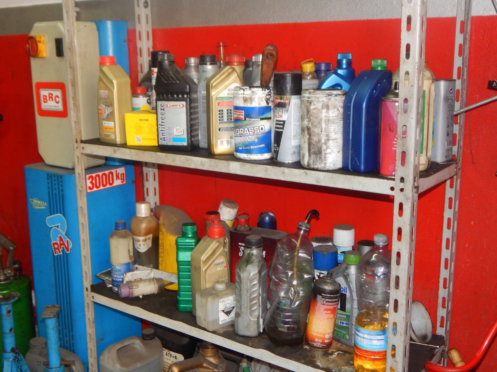 Shelves of assorted cleaning chemicals and spray bottles in a storage room