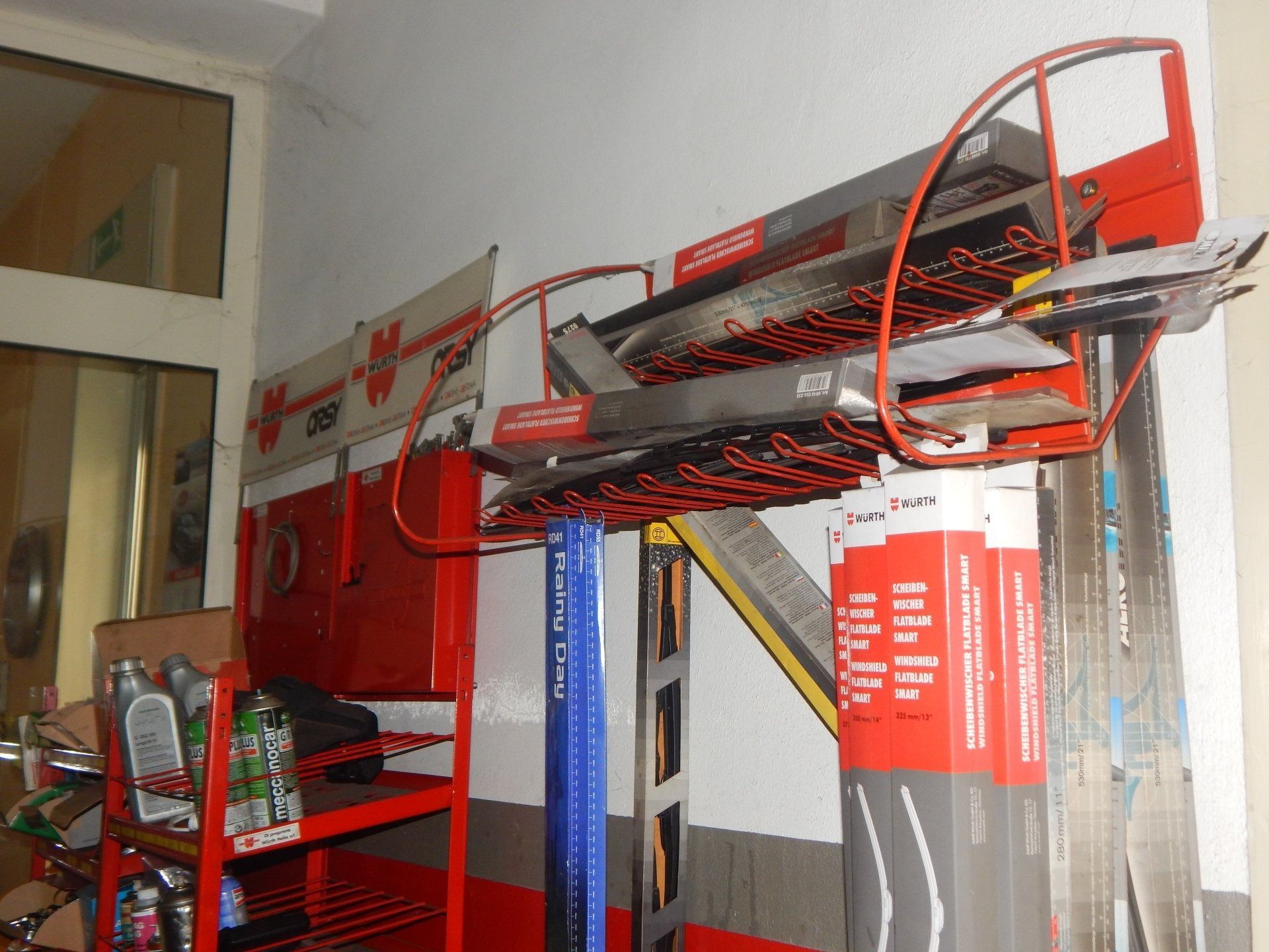 Red fire truck ladder extended inside a building, with rescue equipment and hoses nearby