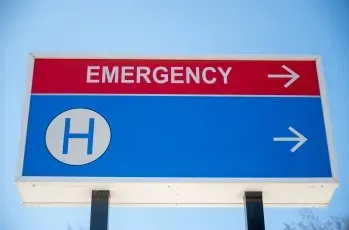 A blue and red sign that says emergency on it