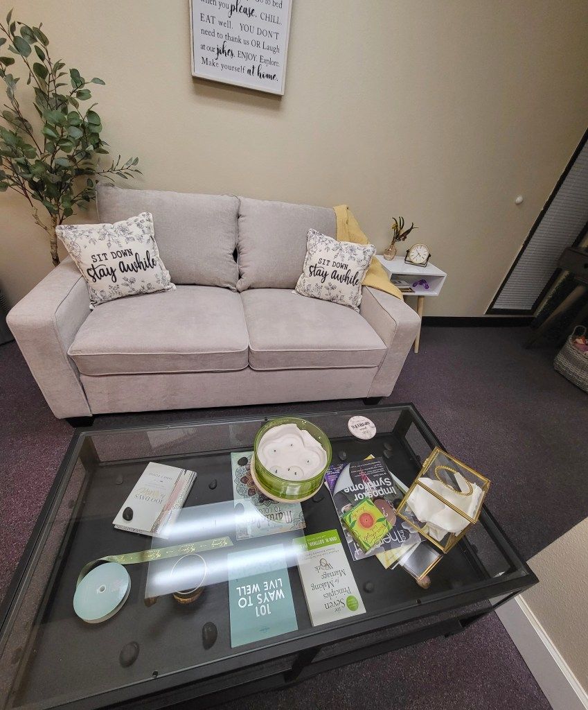 A living room with a couch and a glass coffee table.