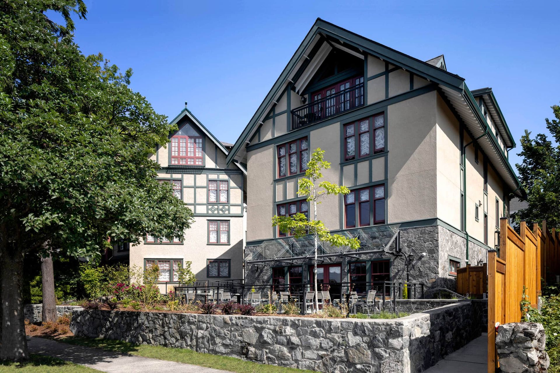 A large building with a stone wall in front of it