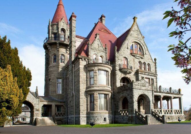 A large stone castle with a red roof