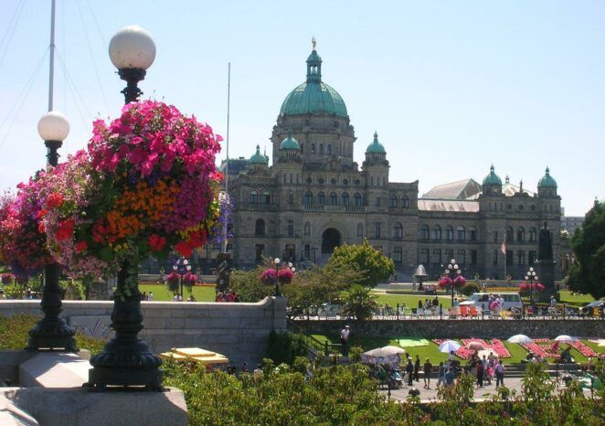 A large building with a dome and flowers in front of it