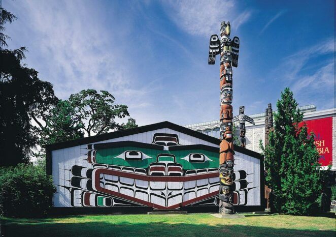 A building with a totem pole in front of it