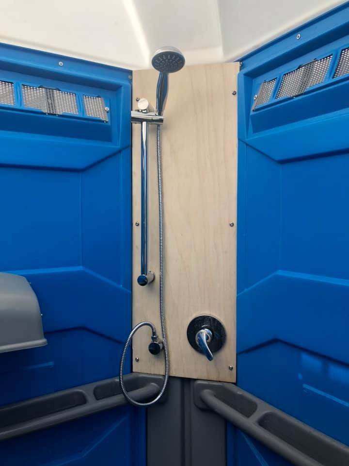 A Bathroom With a Shower Head on the Wall — Absoloo Hire Pty Ltd in Forster, NSW