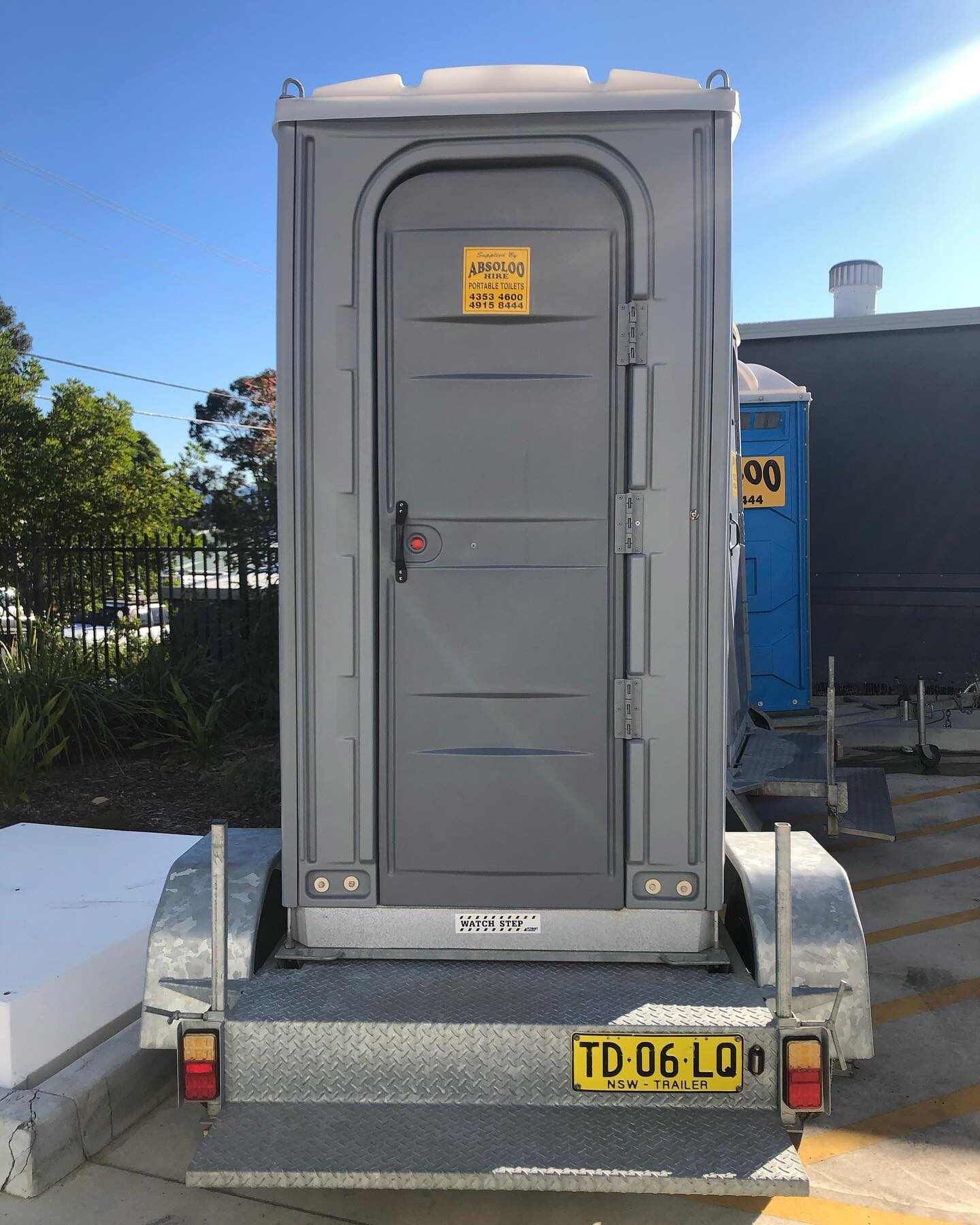 A Portable Toilet is Sitting on Top of a Trailer — Absoloo Hire Pty Ltd in Newcastle, NSW