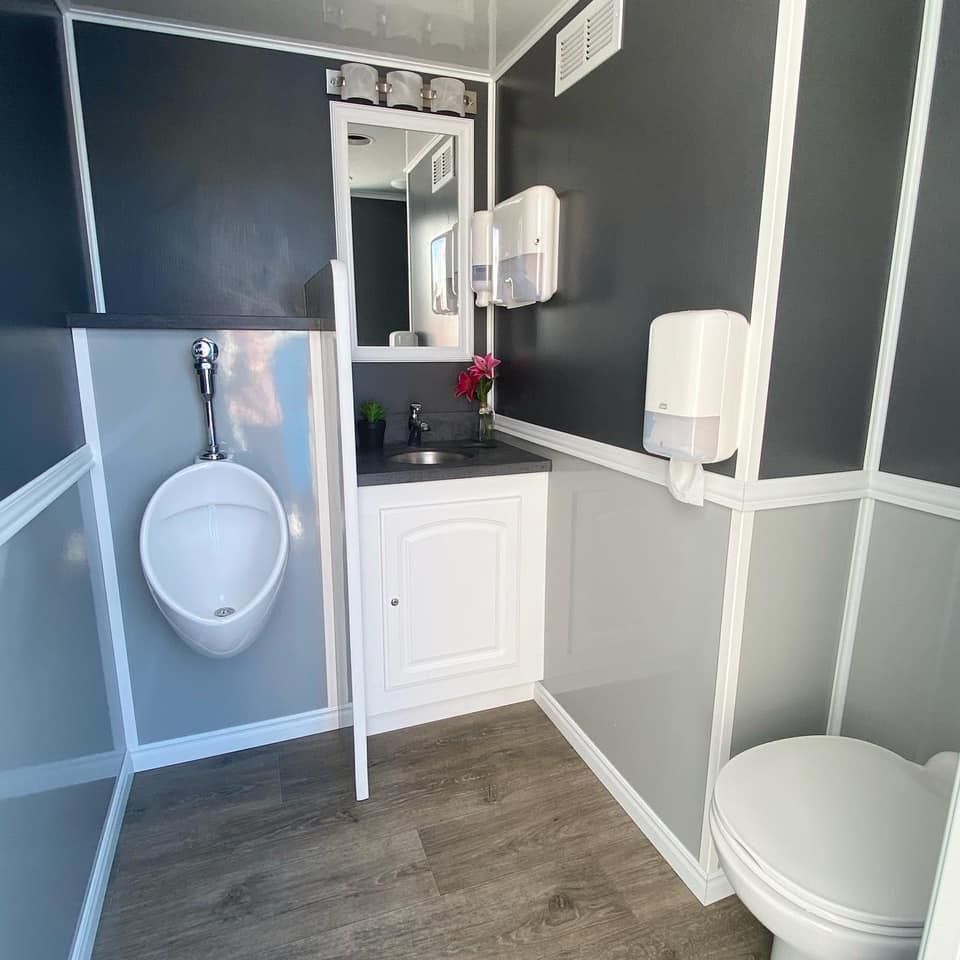 A Bathroom With a Sink, Toilet and Mirror — Absoloo Hire Pty Ltd in Hunter Valley, NSW
