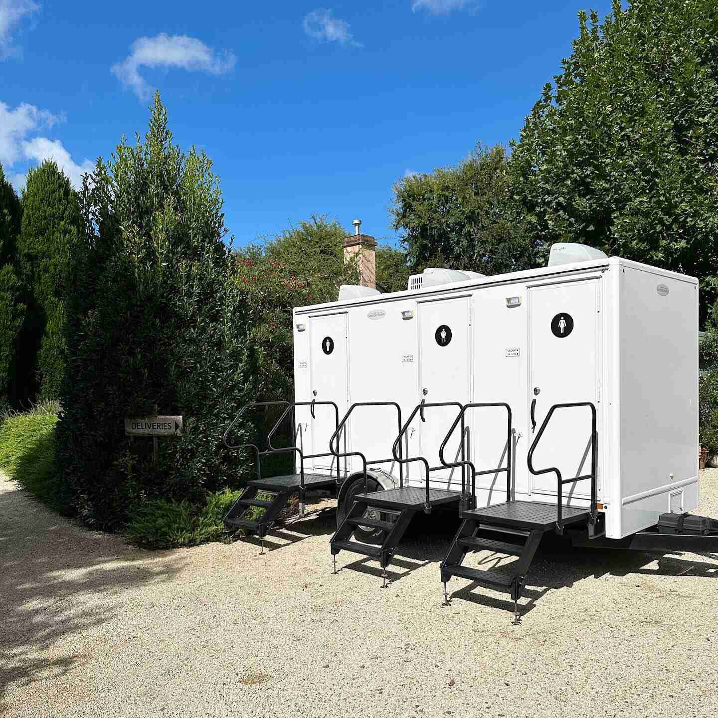 A Row of Restroom Are Parked Next to Each Other in a Gravel Lot — Absoloo Hire Pty Ltd in Hunter Valley, NSW

