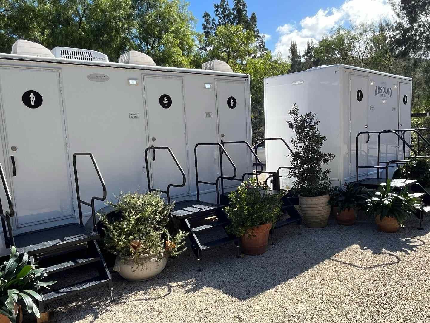 Two Portable Toilets Are Parked Next to Each Other — Absoloo Hire Pty Ltd in Morisset, NSW