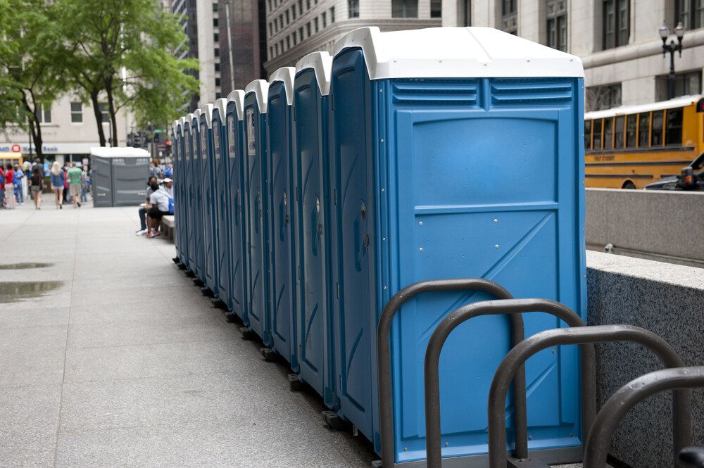 A Row of Portable Toilets Are Lined Up on a Sidewalk — Absoloo Hire Pty Ltd in Newcastle, NSW