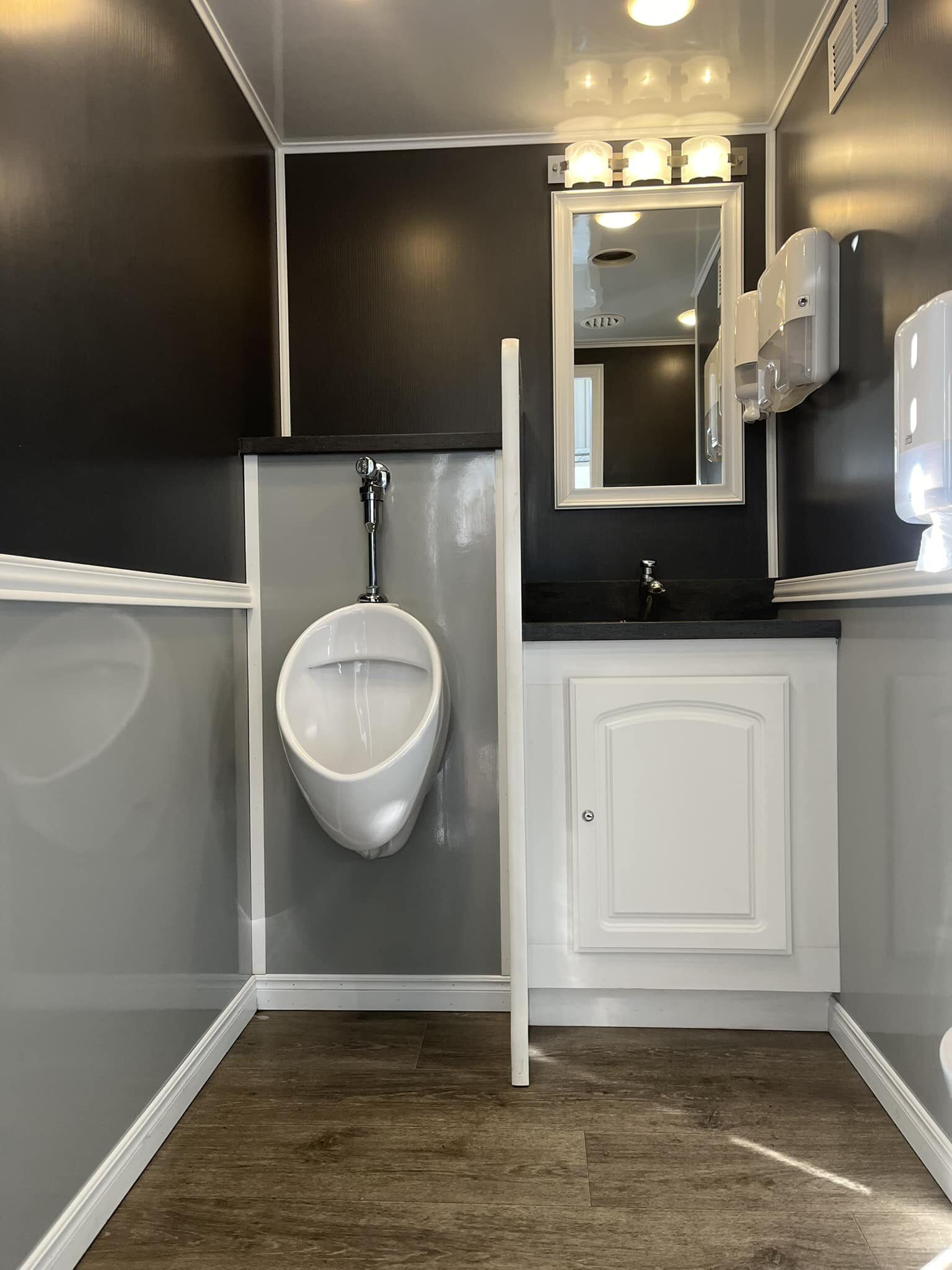 A Bathroom With a Sink and Mirror — Absoloo Hire Pty Ltd in Coffs Harbour, NSW