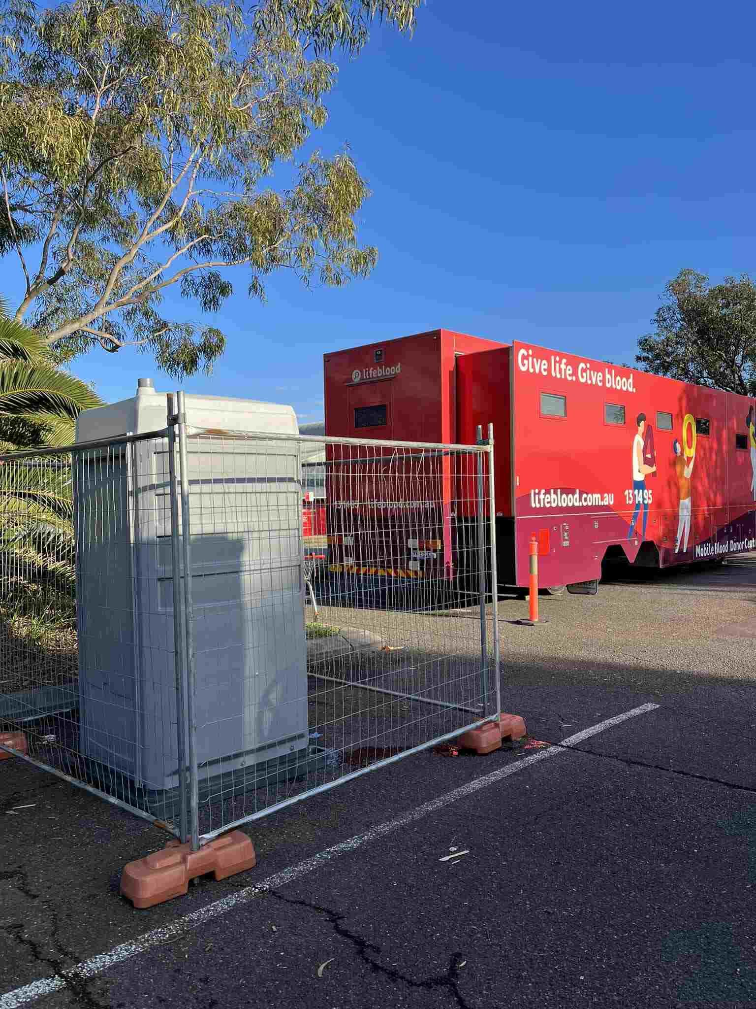 A Portable Toilet is Parked in a Parking Lot — Absoloo Hire Pty Ltd in Coffs Harbour, NSW