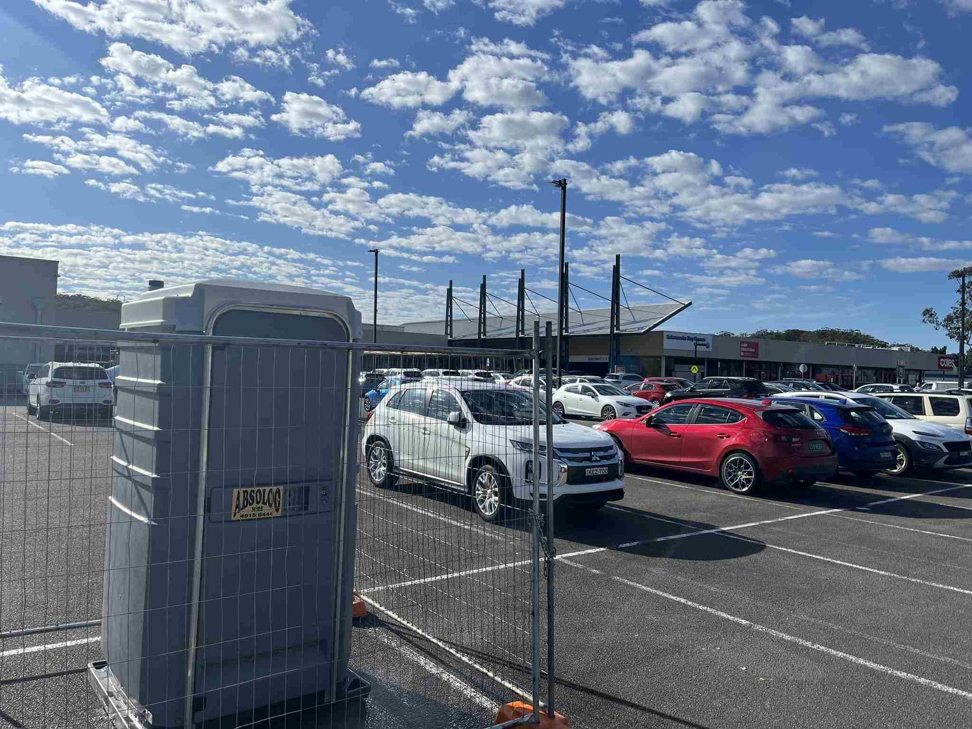 A Portable Toilet is Parked in a Parking Lot — Absoloo Hire Pty Ltd in Port Macquarie, NSW