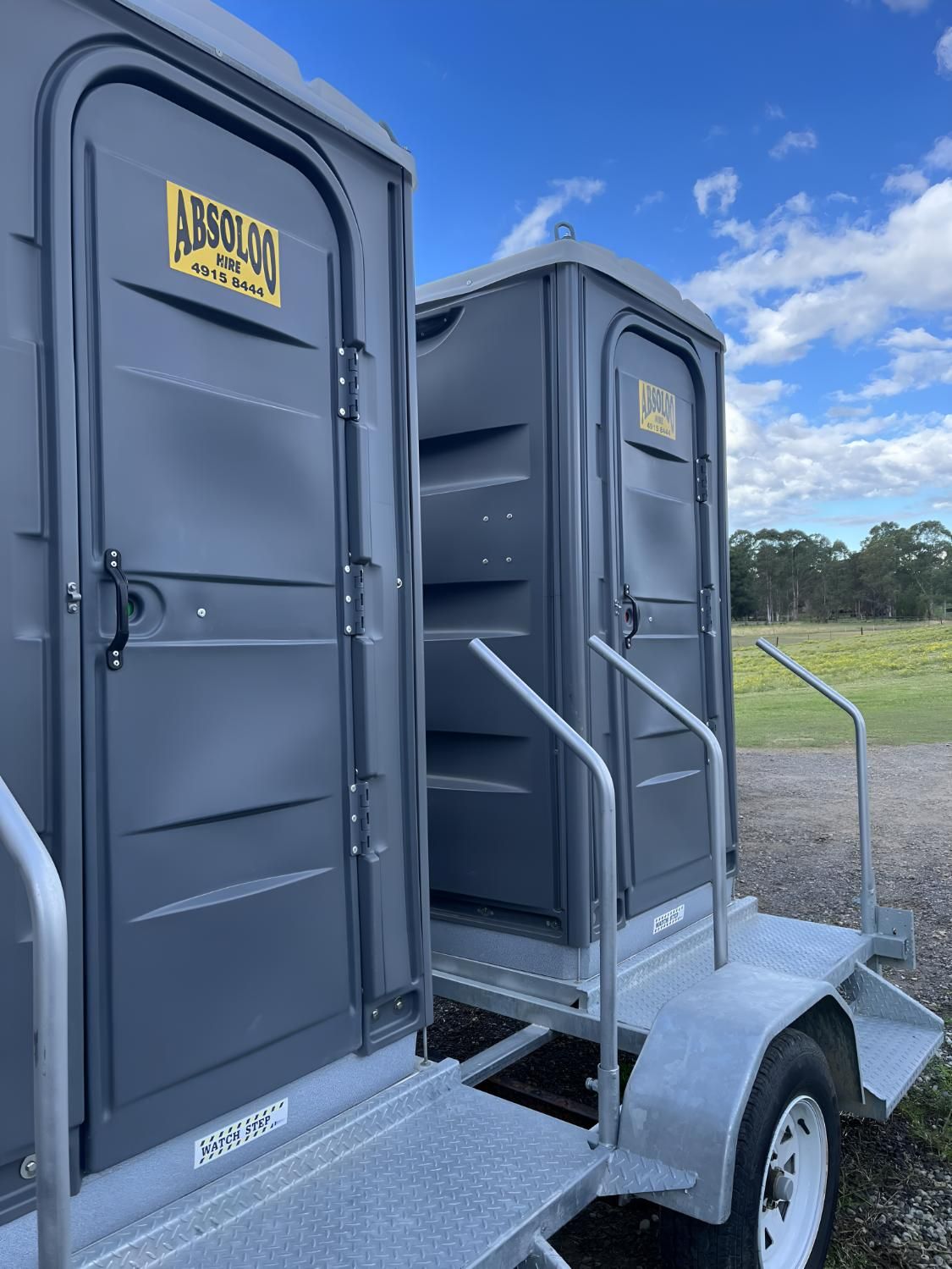Two Portable Toilets Are Sitting on Top of a Trailer — Absoloo Hire Pty Ltd In Morisset, NSW