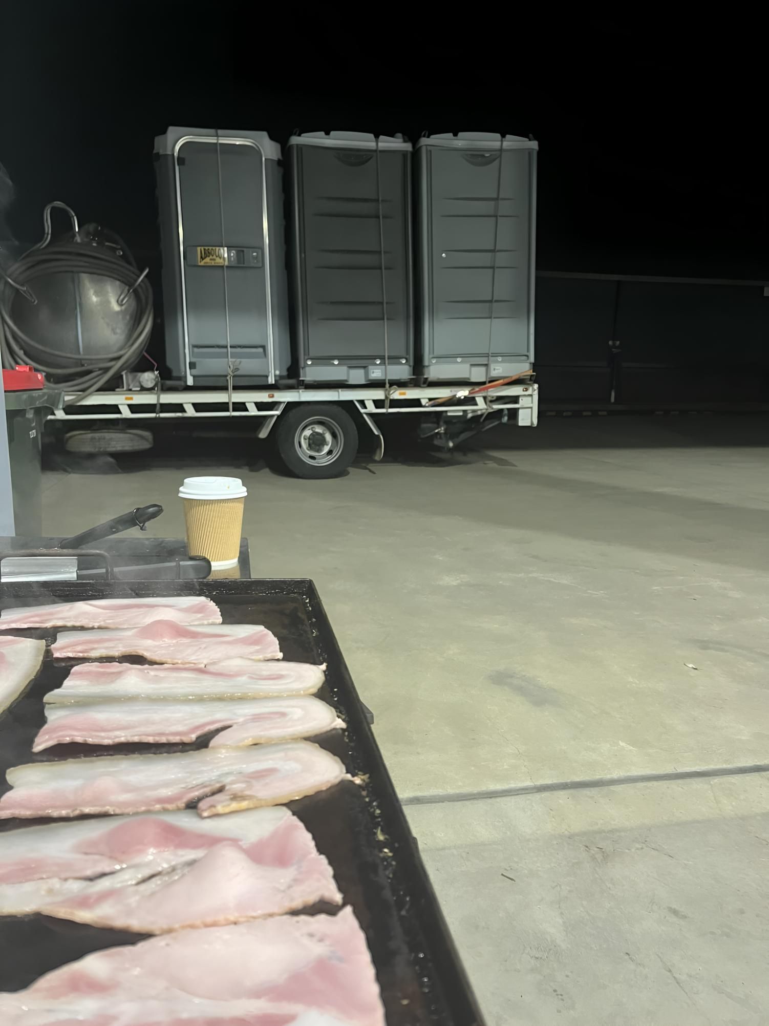 A Tray of Bacon is Sitting on a Table in Front of a Truck — Absoloo Hire Pty Ltd In Morisset, NSW