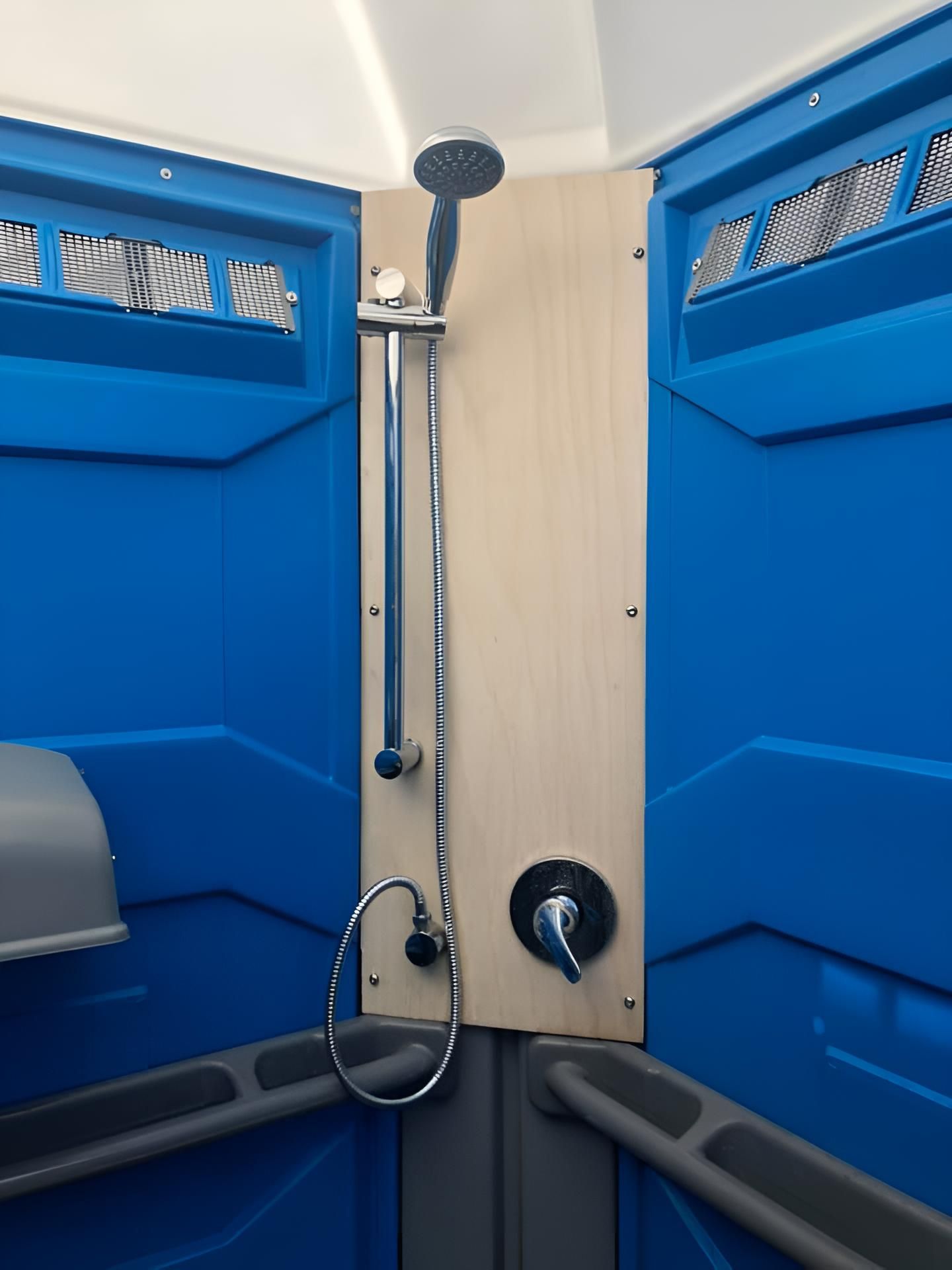 A Blue Bathroom With a Shower Head on the Wall — Absoloo Hire Pty Ltd In Morisset, NSW