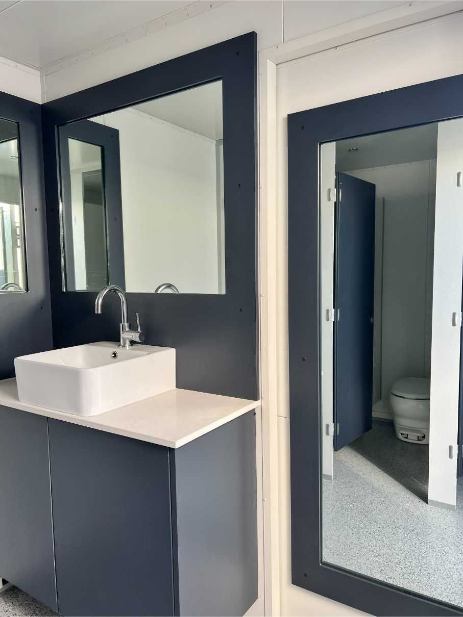 A Bathroom With a Sink and a Toilet — Absoloo Hire Pty Ltd in Morisset, NSW