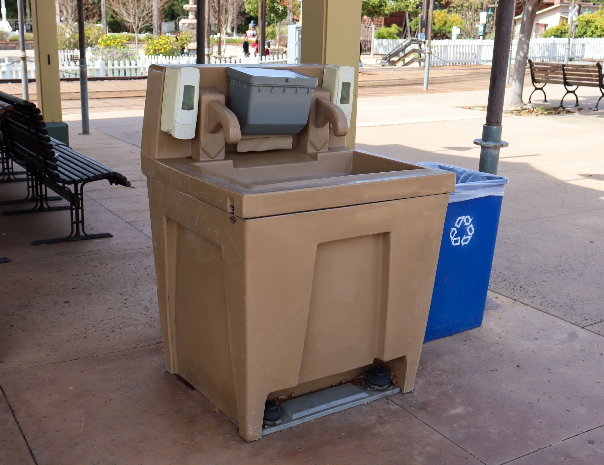 Three Portable Sinks Are Lined Up in Front of a Concrete Wall — Absoloo Hire Pty Ltd in Taree, NSW