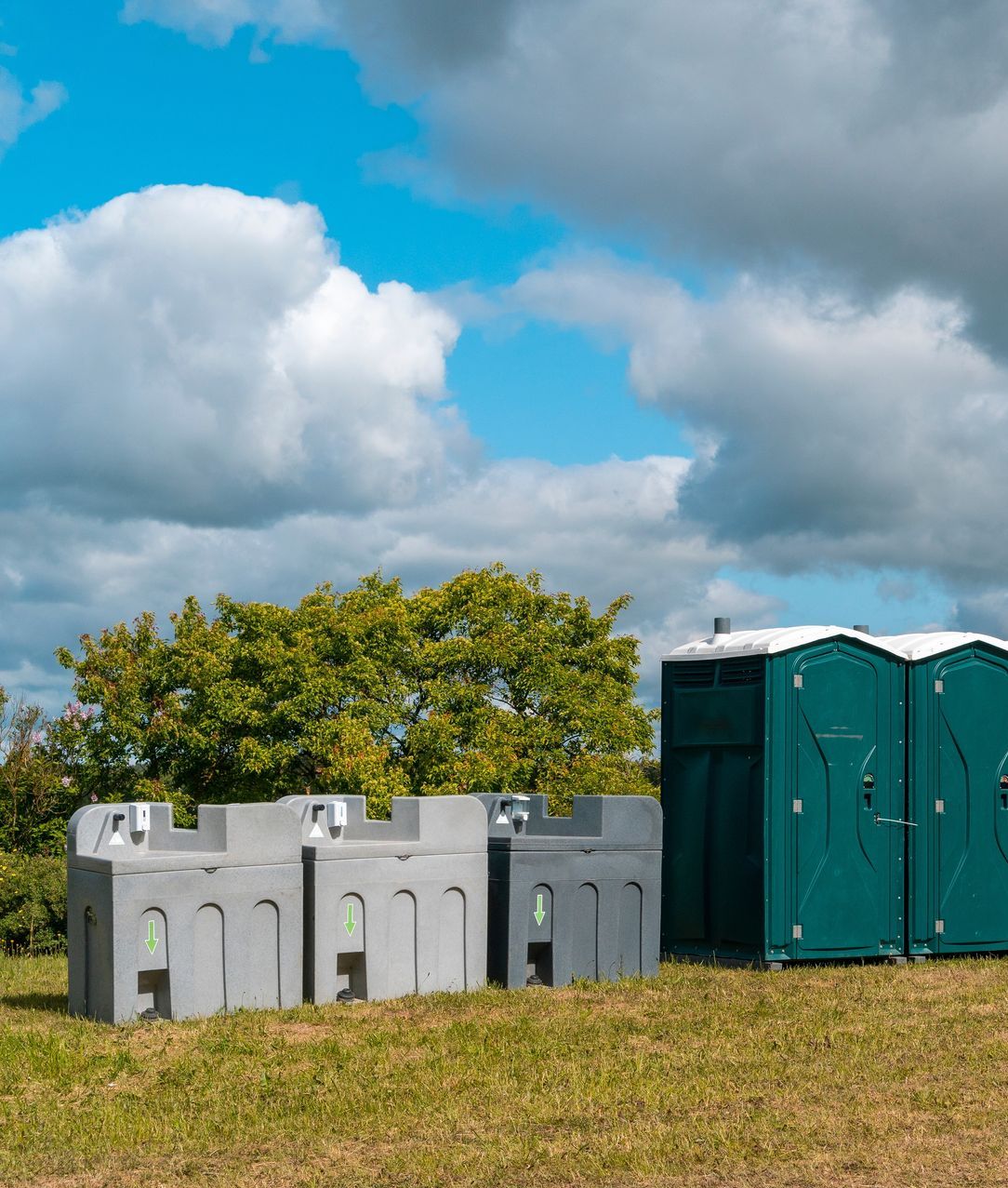 Three Portable Sinks Are Lined Up in Front of a Concrete Wall — Absoloo Hire Pty Ltd in Forster, NSW