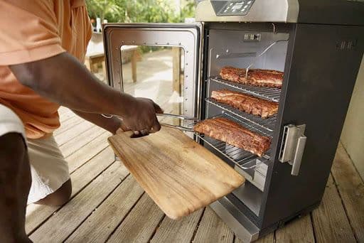 Source: Char-Broil Man removing ribs from electric smoker