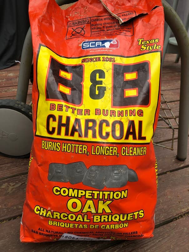 Credit: Extraordinary BBQ Opened bag of B&B Competition Oak Charcoal Briquets leaning against a weber grill