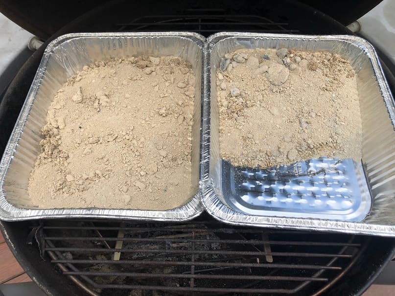 Two trays side by side displaying different amounts of charcoal ash