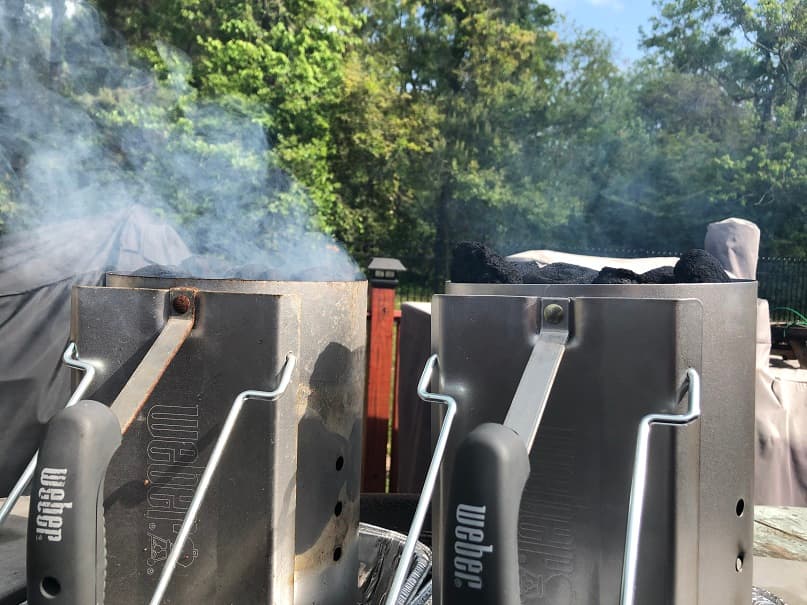 two charcoal chimneys emitting smoke