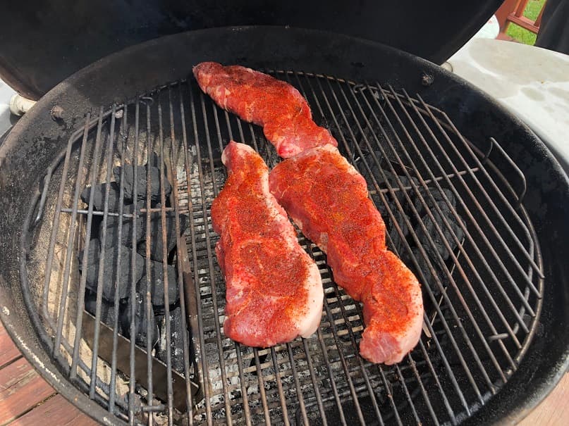 Pork ribs cooking over a charcoal grill