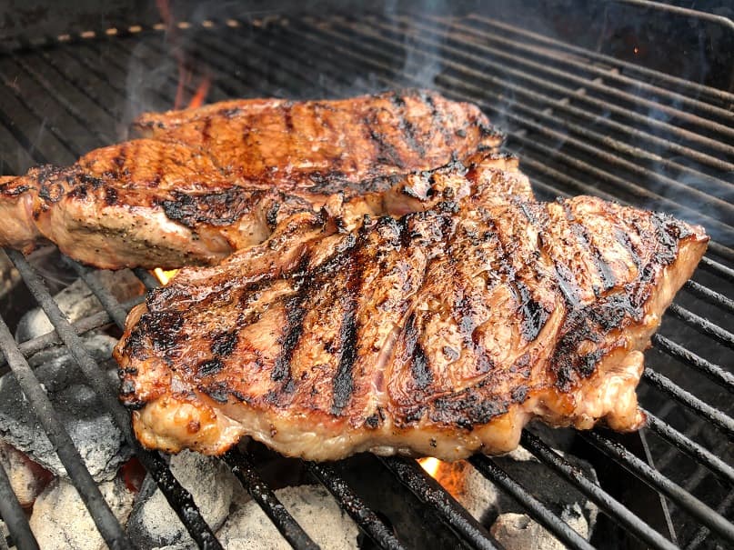 Steaks on a charcoal grill