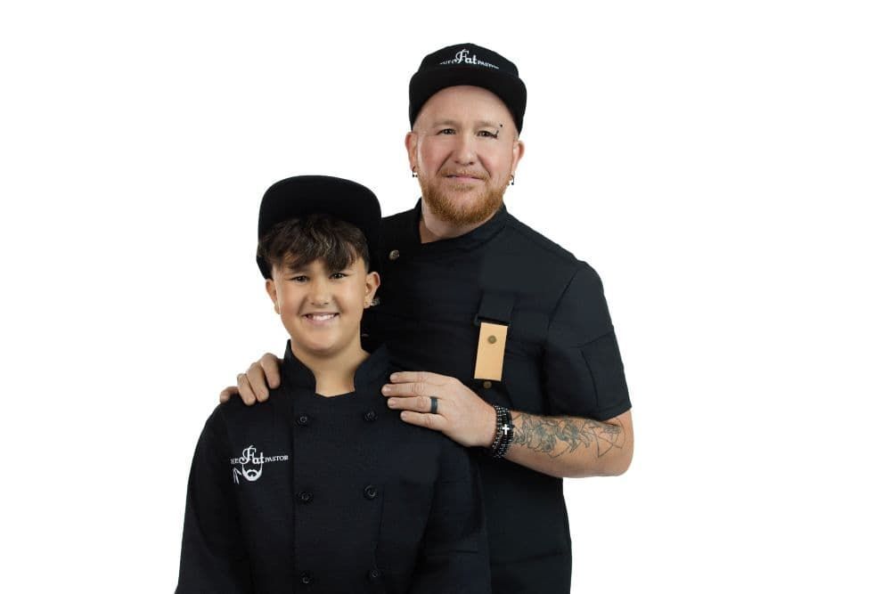 Team B&B Future All Star Asher Niles and his father Shawn in black uniforms posing together against a white background