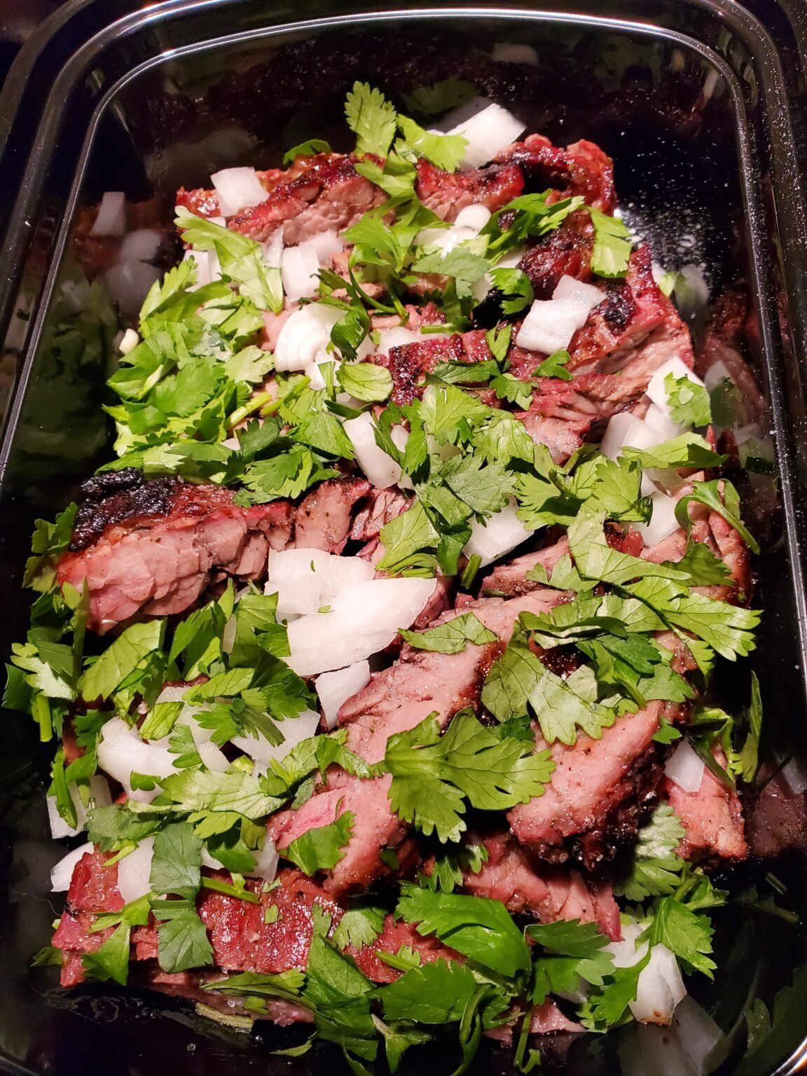 grilled carne asada cut up with cilantro and onions
