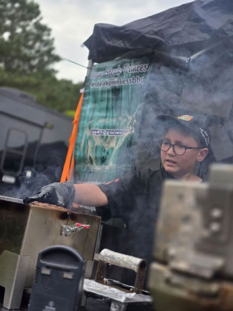 Team B&B Future All Star Hollis Holt tending an outdoor grill