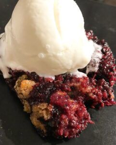 blackberry cobbler with scoop of ice cream on top