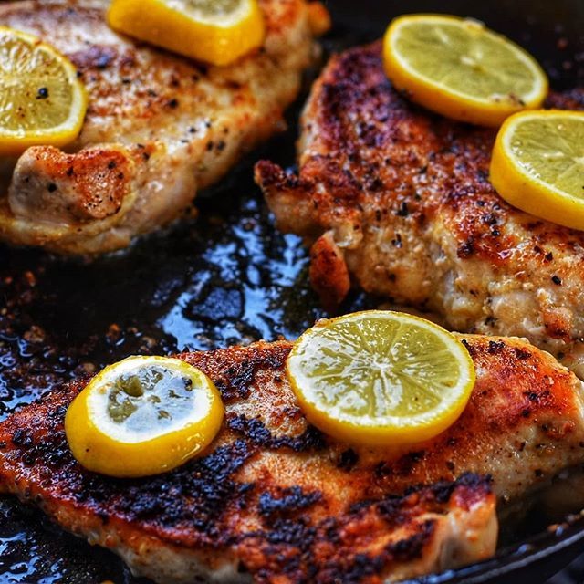 herb crusted chicken in cast iron pan with lemon slices; chicken breast grill