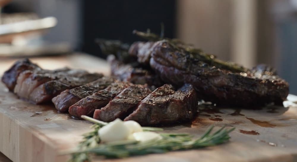 Reverse Sear Ribeye with sprigs of rosemary