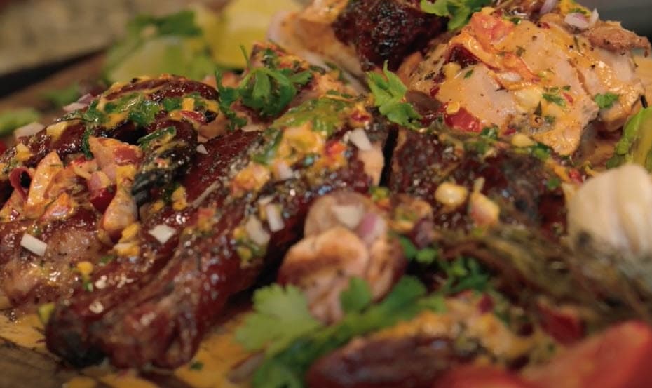 grilled spatchcok chicken topped with salsa